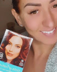 Video of happy woman using Tints of Nature 7R Permanent Hair Dye.